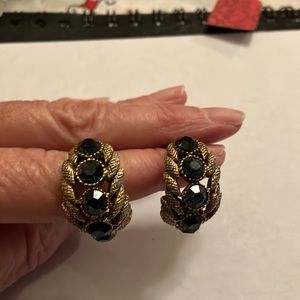 Gold tone earring with sapphire colored stones.